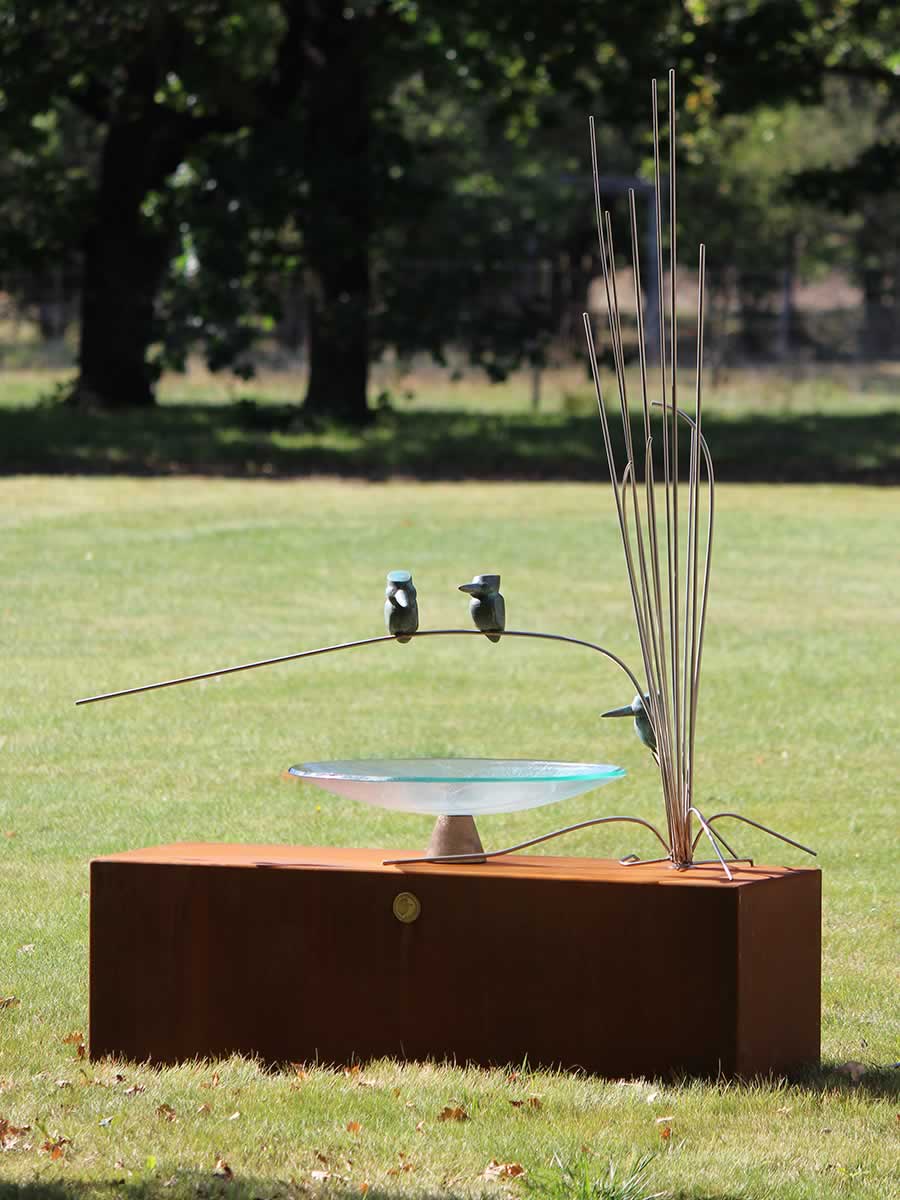 Glass dish birdbath on corten steel plinth, stainless steel reeds, bronze birds