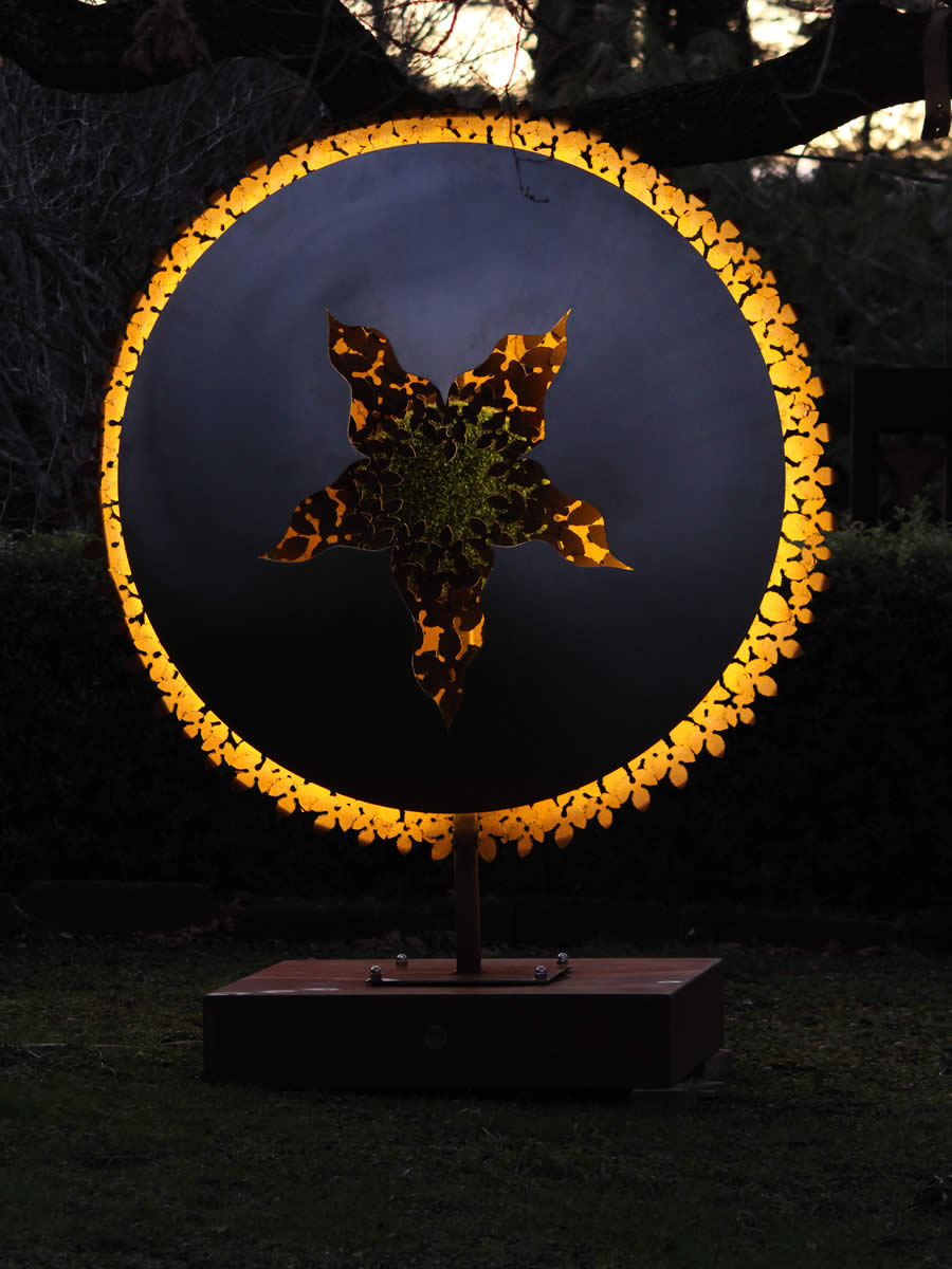 1.7m diameter, stainless steel, corten steel, LED and a tuft of faux turf, also available as wall hung