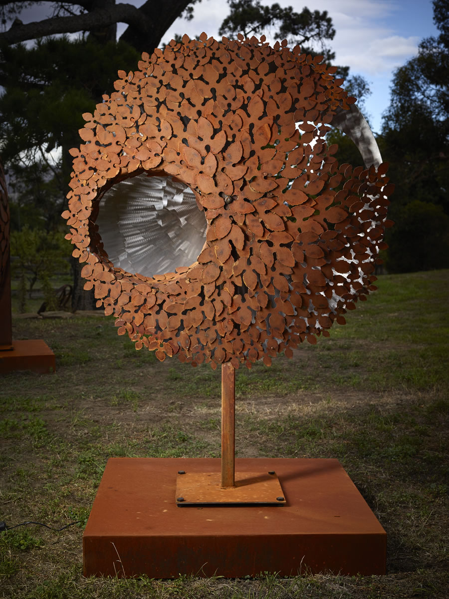 1.2m diameter, 2m tall, two sided corten/stainless steel with exterior LED lighting (side 2)